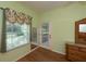Bedroom features a garden view and updated flooring at 1274 White Oak Trl, Port Charlotte, FL 33948