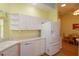 Kitchen with white cabinets, dishwasher, and refrigerator at 1274 White Oak Trl, Port Charlotte, FL 33948