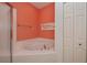 Bathroom features a large garden tub and coral walls at 1274 White Oak Trl, Port Charlotte, FL 33948