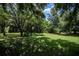 Open green space with large trees and natural landscaping at 1274 White Oak Trl, Port Charlotte, FL 33948