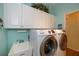 Laundry room with washer, dryer, cabinets, and utility sink at 1274 White Oak Trl, Port Charlotte, FL 33948