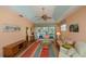 Living room features wicker furniture, ceiling fan and access to patio at 1274 White Oak Trl, Port Charlotte, FL 33948