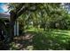 Large backyard with mature trees providing shade and privacy at 1274 White Oak Trl, Port Charlotte, FL 33948