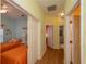 Hallway with light wood flooring and doors to bedrooms and bathrooms at 1274 White Oak Trl, Port Charlotte, FL 33948