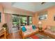 Living room with sliding doors leading to a patio and view of lush trees at 1274 White Oak Trl, Port Charlotte, FL 33948