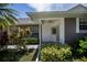 Exterior view showing covered patio and landscaping at 1274 White Oak Trl, Port Charlotte, FL 33948