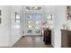 White shiplap walls and hardwood floors in entryway with view of front door at 1735 Boca Raton Ct, Punta Gorda, FL 33950