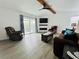 Relaxing living room featuring a fireplace, comfortable seating, and wood beam accents at 14300 Worthwhile Rd, Port Charlotte, FL 33953