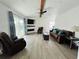 Spacious living room with a modern fireplace, comfortable seating, and wood beams at 14300 Worthwhile Rd, Port Charlotte, FL 33953