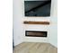 Modern electric fireplace with a wood mantel and shiplap wall at 14300 Worthwhile Rd, Port Charlotte, FL 33953