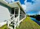 Home exterior showcasing a screened porch overlooking a canal at 14300 Worthwhile Rd, Port Charlotte, FL 33953