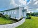 Exterior view of the house, showcasing its landscaping and walkway at 14300 Worthwhile Rd, Port Charlotte, FL 33953