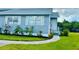 Front view of the house with a manicured lawn at 14300 Worthwhile Rd, Port Charlotte, FL 33953