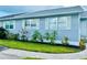 Quaint light-blue house with a well-maintained lawn and sidewalk at 14300 Worthwhile Rd, Port Charlotte, FL 33953