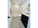 Clean bathroom with tub, shower, and dark vanity at 14300 Worthwhile Rd, Port Charlotte, FL 33953