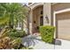 Front entry with double doors, decorative sun, and manicured shrubs at 13139 Preserve Ct, Port Charlotte, FL 33953