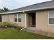 Side view of the house showing a brown door and landscaping at 7633 W Lenox Cir, Punta Gorda, FL 33950