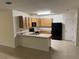Kitchen with wood cabinets and black appliances at 7633 W Lenox Cir, Punta Gorda, FL 33950
