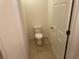 Clean and simple half bathroom with toilet and door at 7633 W Lenox Cir, Punta Gorda, FL 33950