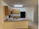 Kitchen with wood cabinets, black appliances, and an island at 7633 W Lenox Cir, Punta Gorda, FL 33950