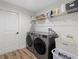 Laundry room with washer, dryer, and shelving at 8450 Malcolm Ave, North Port, FL 34287