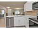 Modern kitchen with white cabinets, island, and stainless steel appliances at 1530 Laurel Brook Ln, Port Charlotte, FL 33953
