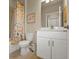 Bathroom with white vanity, shower/tub combo, and floral shower curtain at 1530 Laurel Brook Ln, Port Charlotte, FL 33953