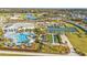 Aerial view of community pool, clubhouse, pickleball courts at 1530 Laurel Brook Ln, Port Charlotte, FL 33953