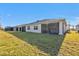Home exterior showcasing a large backyard and a screened patio at 1530 Laurel Brook Ln, Port Charlotte, FL 33953