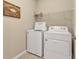 Laundry room with washer, dryer, and shelving for storage at 1530 Laurel Brook Ln, Port Charlotte, FL 33953