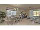 Bright dining area with a table and chairs, adjacent to a living room at 1530 Laurel Brook Ln, Port Charlotte, FL 33953
