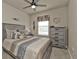 Well-lit bedroom with a comfortable bed, dresser, and window at 1530 Laurel Brook Ln, Port Charlotte, FL 33953