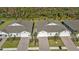 Aerial view of three attached homes with identical architecture and landscaping at 1530 Laurel Brook Ln, Port Charlotte, FL 33953