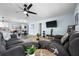 Open-concept living space with gray sectional sofa and a view into the kitchen and dining area at 635 Erroll St, Port Charlotte, FL 33952