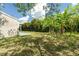Backyard with grass, trees, and a patio at 2624 Lee St, Punta Gorda, FL 33950