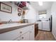 Laundry room with washer, dryer, and extra storage at 3730 Turtle Dove Blvd, Punta Gorda, FL 33950