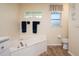 Relaxing bathroom with corner tub, window, and wood flooring at 3730 Turtle Dove Blvd, Punta Gorda, FL 33950
