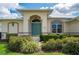 Welcoming exterior with teal front door and manicured landscaping at 3730 Turtle Dove Blvd, Punta Gorda, FL 33950