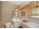 Bathroom features a garden tub, vanity, and toilet at 2490 Chartwell Ave, North Port, FL 34288