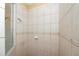 Beige tiled shower with glass enclosure at 2490 Chartwell Ave, North Port, FL 34288