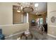 Dining room with a chandelier and view into the living room at 2490 Chartwell Ave, North Port, FL 34288