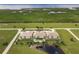 Aerial view of condo complex, pool, and surrounding waterfront landscape at 17084 Acapulco Rd # 222, Punta Gorda, FL 33955