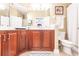 Bathroom with double vanity, wood cabinets, and a shower/tub combo at 17084 Acapulco Rd # 222, Punta Gorda, FL 33955