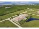 Aerial view showing condo complex near the water, featuring a pool at 17084 Acapulco Rd # 222, Punta Gorda, FL 33955