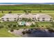 Aerial view of condo building complex with pool, near a pond and waterfront at 17084 Acapulco Rd # 222, Punta Gorda, FL 33955