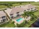 Aerial view of a community with a pool and lush landscaping at 17084 Acapulco Rd # 222, Punta Gorda, FL 33955