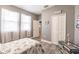 Bedroom with white bed frame, coastal decor, and adjacent bathroom at 17084 Acapulco Rd # 222, Punta Gorda, FL 33955