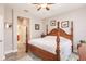 Bright bedroom with a wooden post bed and access to bathroom at 17084 Acapulco Rd # 222, Punta Gorda, FL 33955