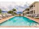 Inviting community pool with plenty of lounge chairs at 17084 Acapulco Rd # 222, Punta Gorda, FL 33955