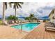 Community pool with lounge chairs and a patio at 17084 Acapulco Rd # 222, Punta Gorda, FL 33955